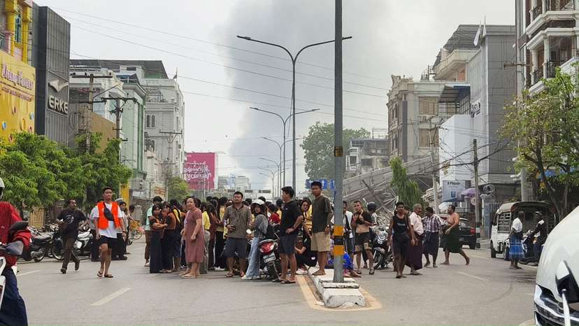 People gather on a street after a strong earthquake struck central Myanmar