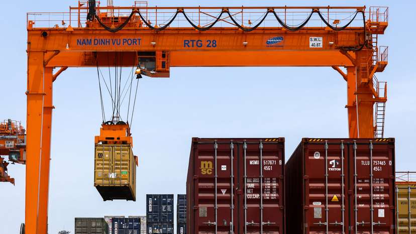 A container is loaded onto a cargo ship while docked at Hai Phong port in Vietnam