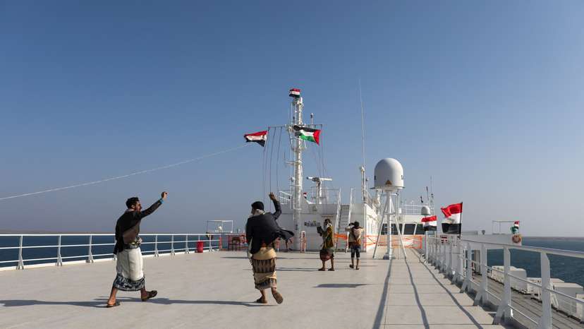 People dance on the deck of the Galaxy Leader commercial ship, seized by Yemen's Houthis last month, off the coast of al-Salif