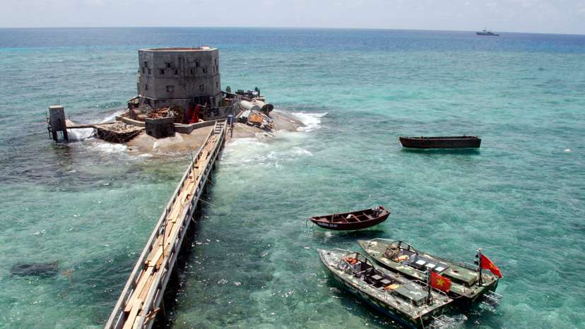 FILE PHOTO: Motorboats anchor at a partially submerged island of Truong Sa islands