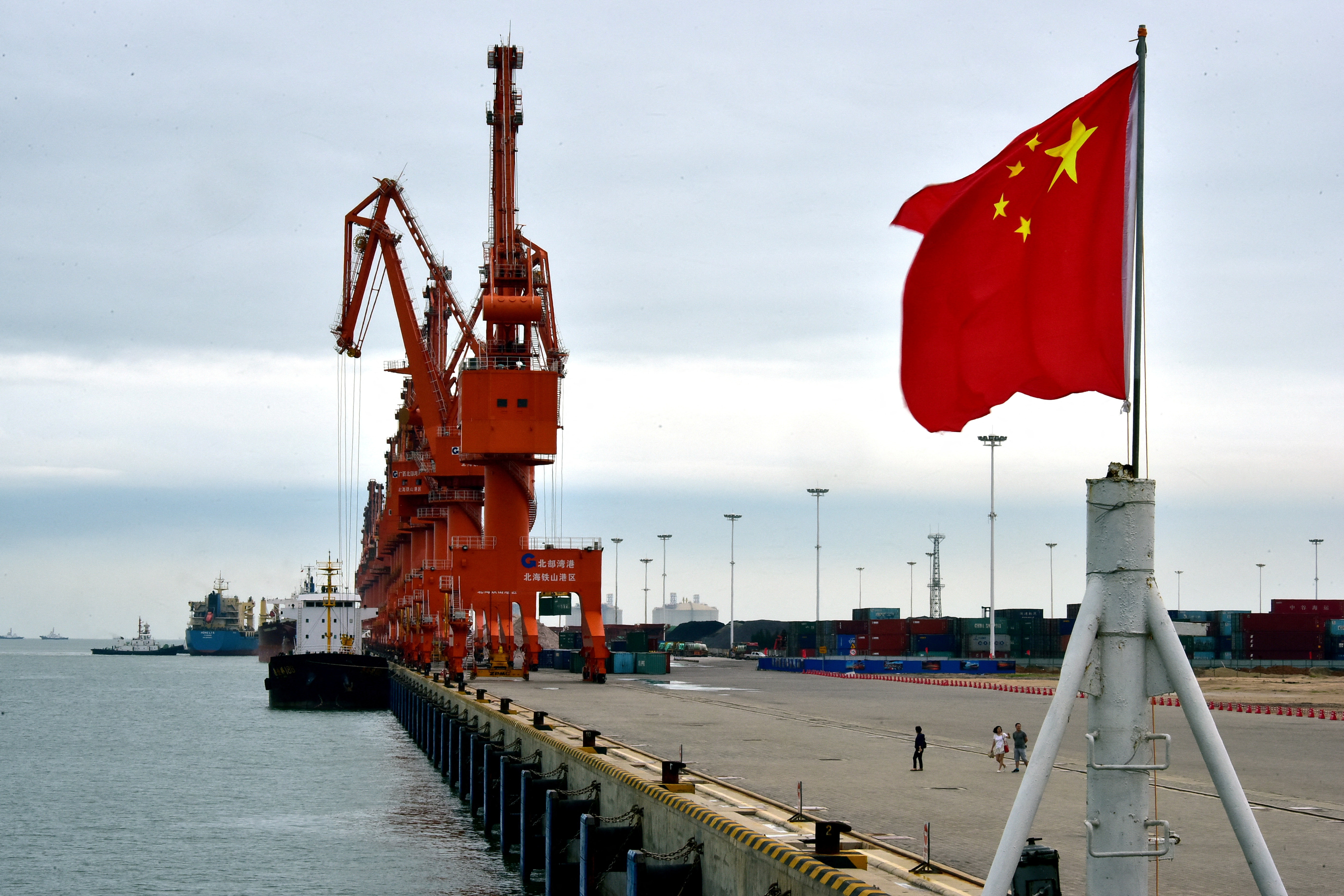A Chinese national flag flies at a port in Beihai