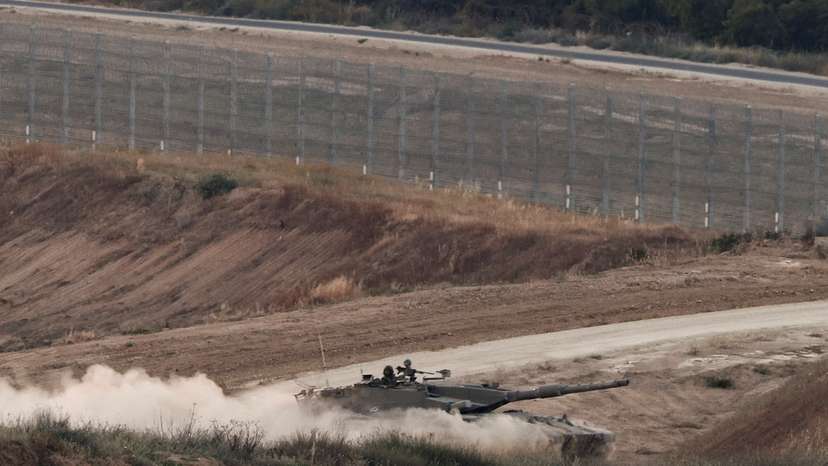 An Israeli tank manoeuvres in Gaza as seen from the Israeli side of the border