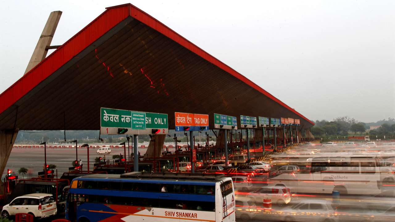 FILE PHOTO: Vehicles pass through a toll plaza in Gurgaon on the outskirts of New Delhi
