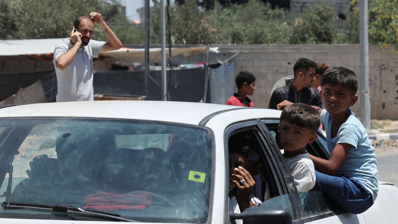 Displaced Palestinian children, who fled north Gaza after they were ordered by Israeli army to move southward, amid Israel-Hamas conflict, travel in a car as they arrive in Nuseirat in the central Gaza Strip