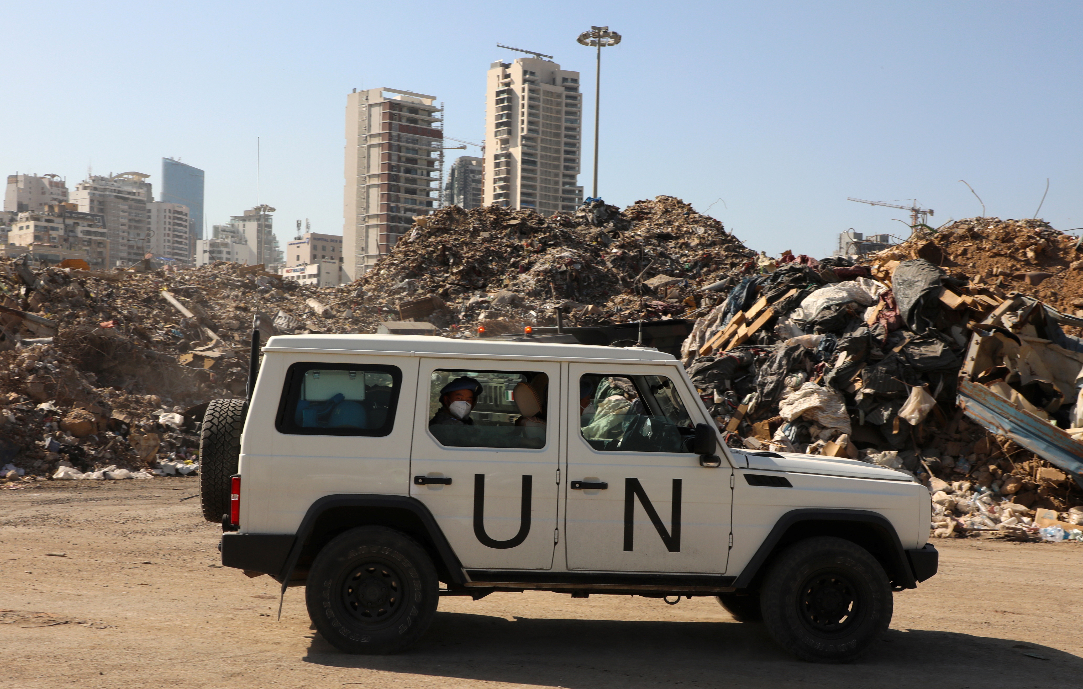 A UN peacekeepers (UNIFIL) vehicle is seen next to a piled up debris at Beirut's port