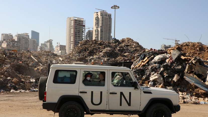 A UN peacekeepers (UNIFIL) vehicle is seen next to a piled up debris at Beirut's port