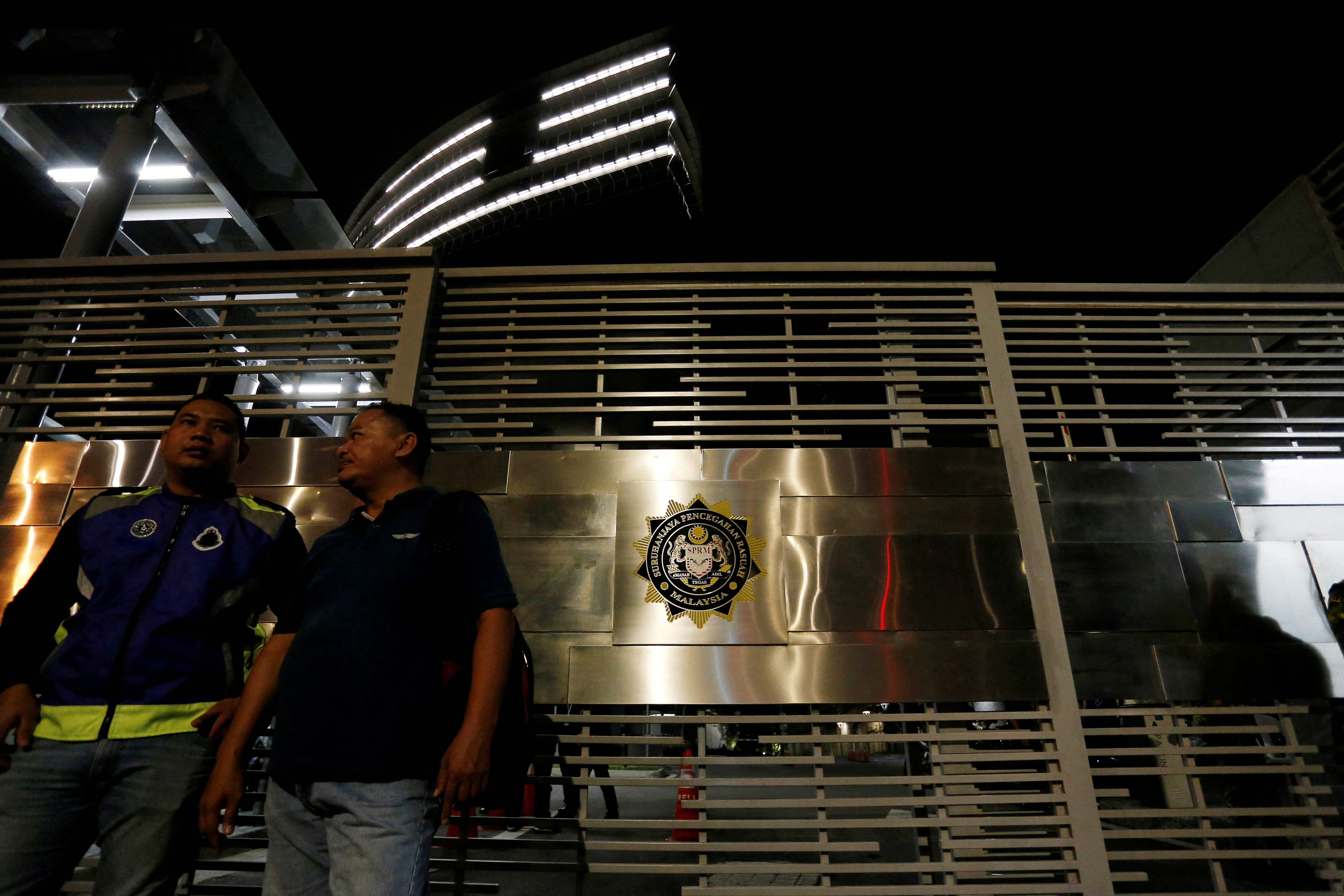 FILE PHOTO: Police officers stand guard outside the MACC headquarters in Putrajaya