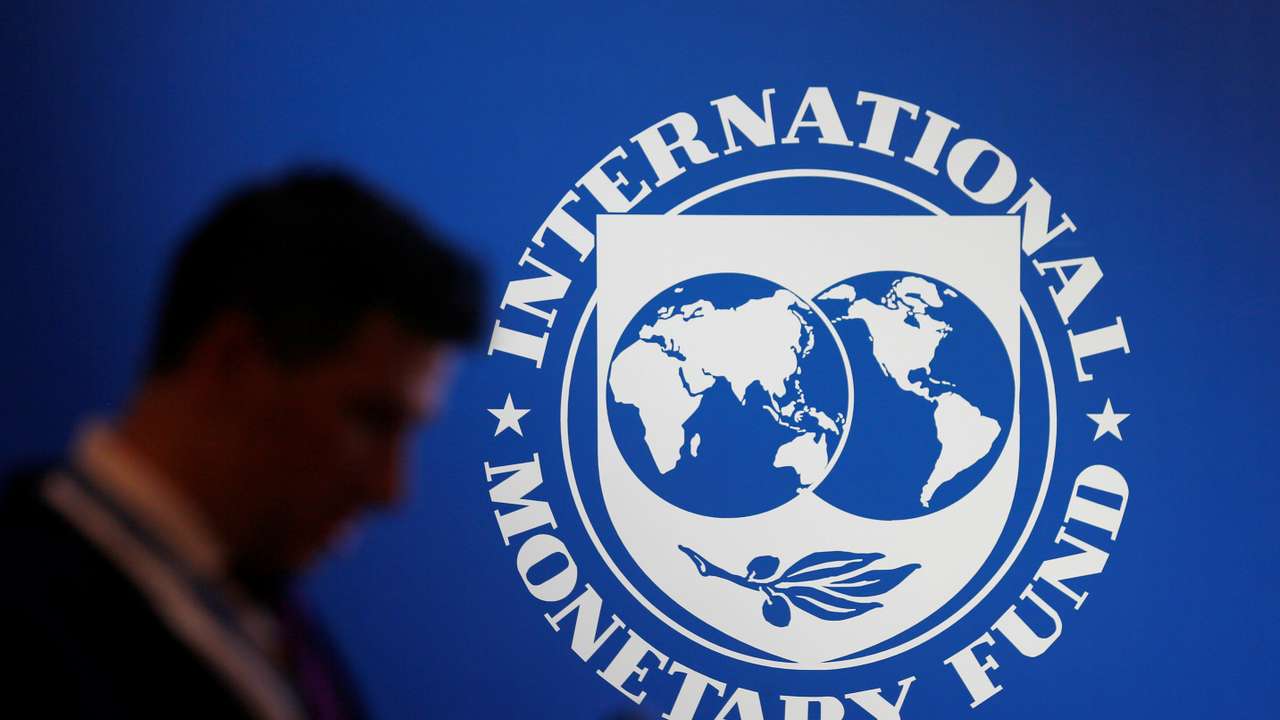 FILE PHOTO: A participant stands near a logo of IMF at the International Monetary Fund - World Bank Annual Meeting 2018 in Nusa Dua, Bali, Indonesia, October 12, 2018. REUTERS/Johannes P. Christo/File Photo