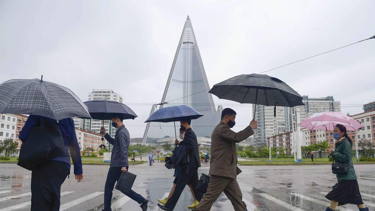 People wearing protective face masks walk amid concerns over the new coronavirus disease (COVID-19) in Pyongyang, North Korea