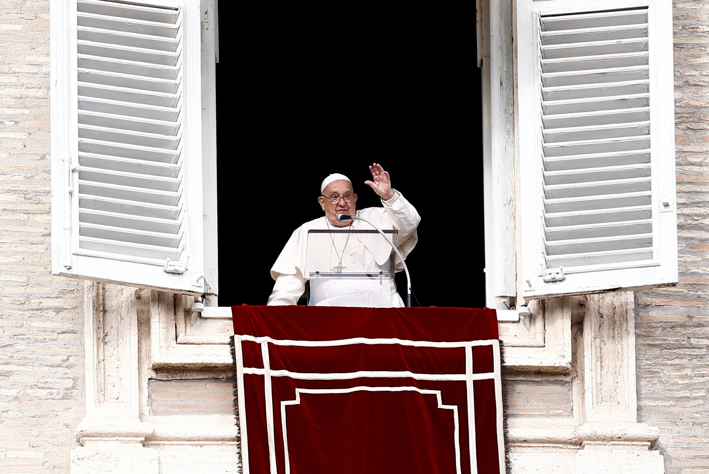 Pope Francis leads the Angelus prayer from his window at the Vatican