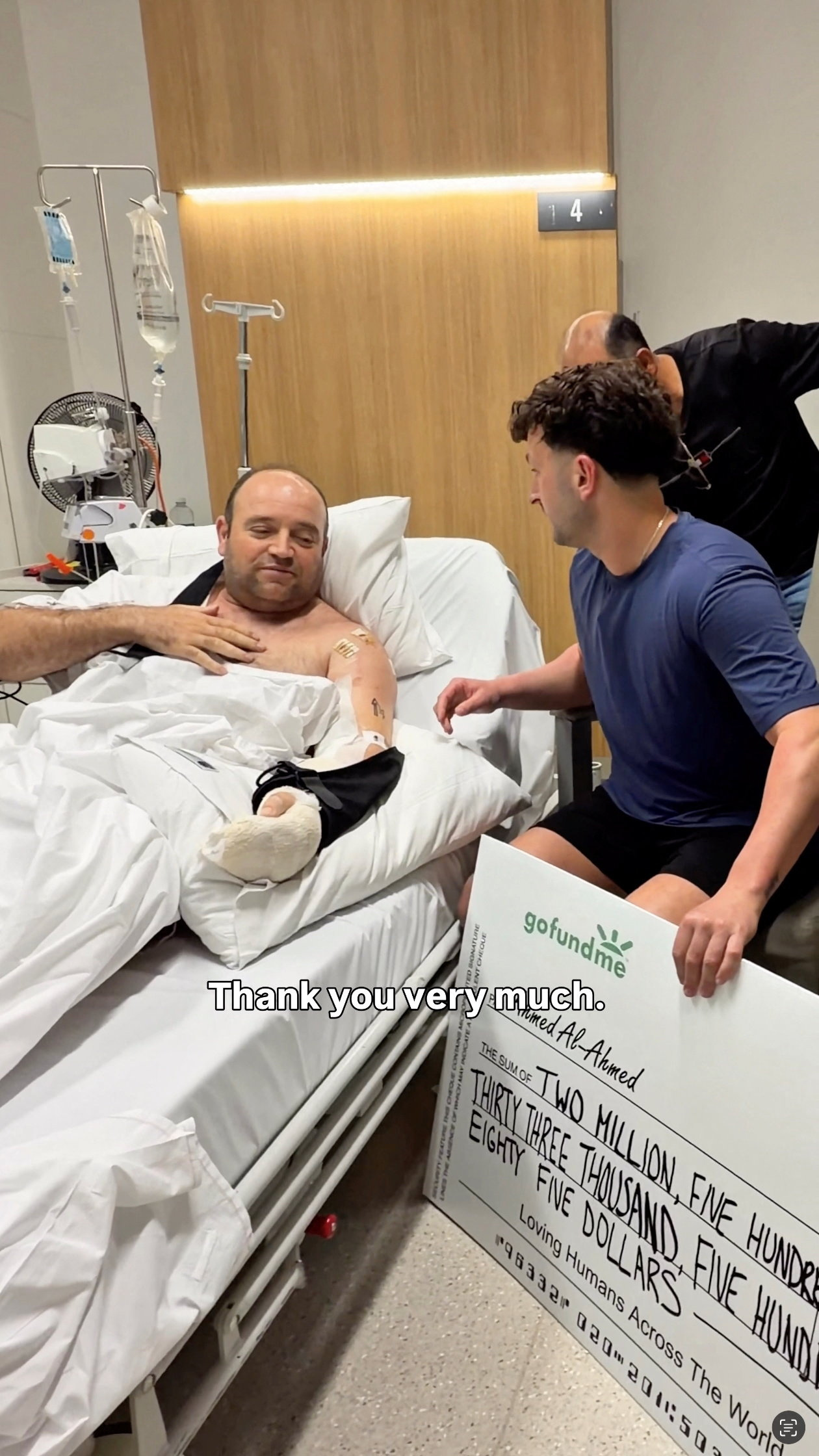 Influencer Zachery Dereniowski gives a donation check to Ahmed Al-Ahmed, the hero at Bondi Shooting
