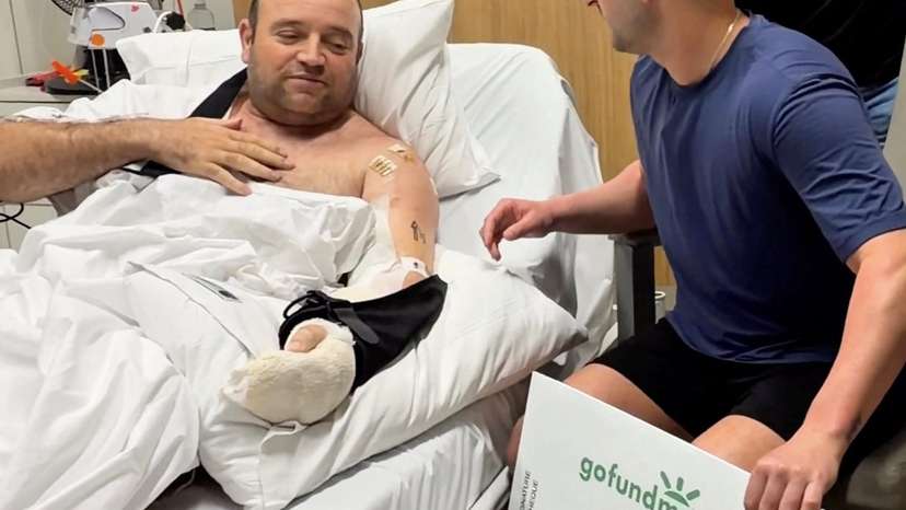 Influencer Zachery Dereniowski gives a donation check to Ahmed Al-Ahmed, the hero at Bondi Shooting