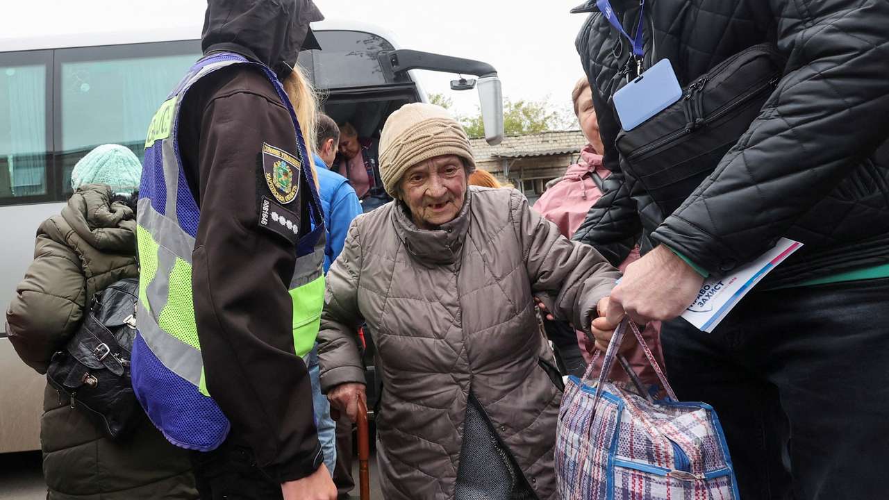 Kupiansk residents, who fled due to Russian military strikes, arrive to an evacuation centre in Kharkiv