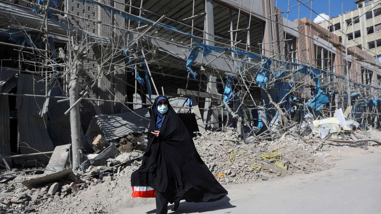A woman walks on the street amid the U.S.-Israeli conflict with Iran, in Tehran