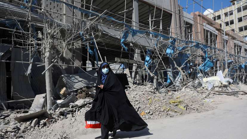 A woman walks on the street amid the U.S.-Israeli conflict with Iran, in Tehran