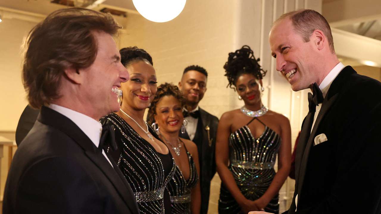 Britain's Prince William, Prince of Wales, reacts as he talks with U.S. actor Tom Cruise, at the London Air Ambulance Charity Gala Dinner at The OWO, in central London