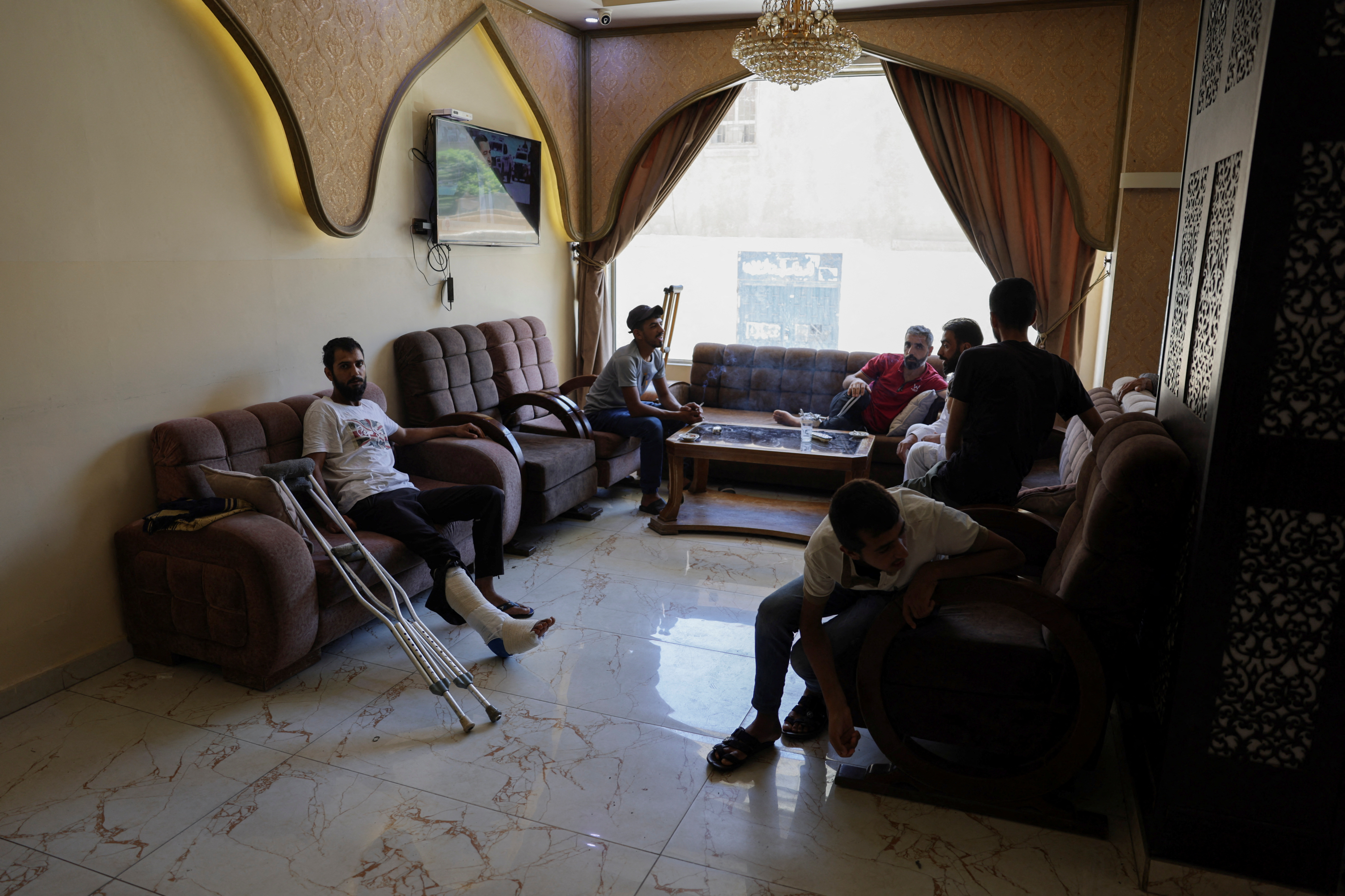 A group of Bedouins who fled sectarian fighting in Syria's Sweida province sits inside a hotel in Damascus