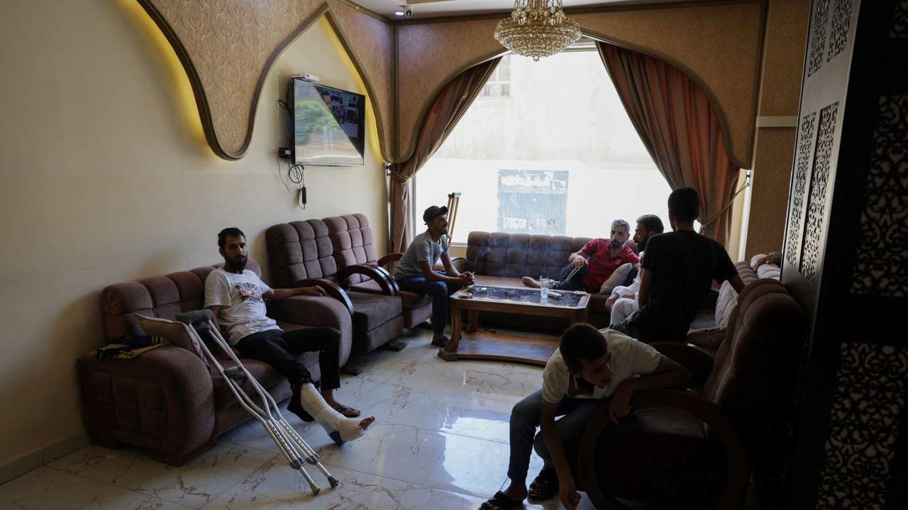 A group of Bedouins who fled sectarian fighting in Syria's Sweida province sits inside a hotel in Damascus