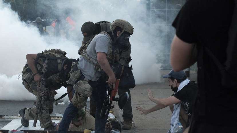 People protest during a standoff with ICE and federal officers in Chicago