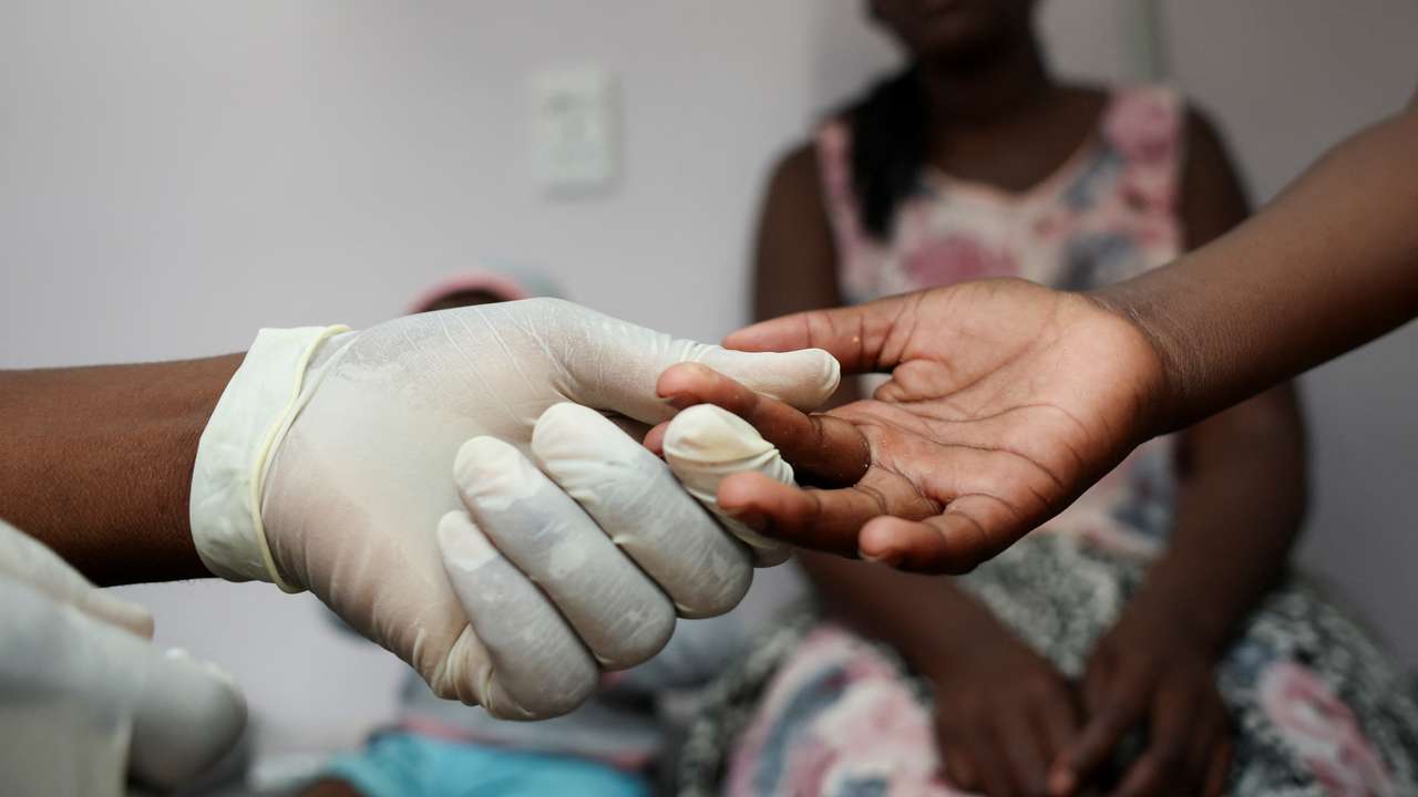 A nurse takes a blood sample from a child for an HIV test at a clinic in Diepsloot