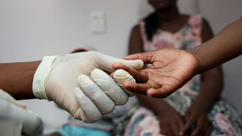 A nurse takes a blood sample from a child for an HIV test at a clinic in Diepsloot
