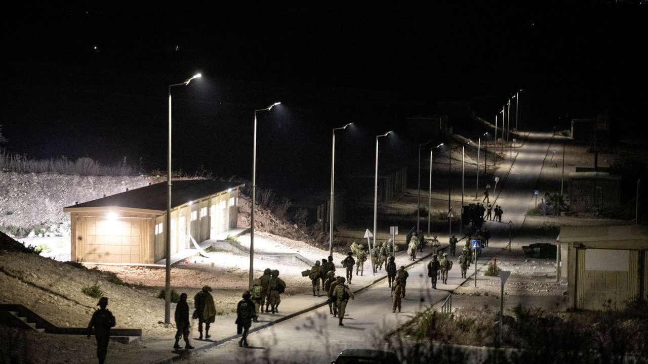 FILE PHOTO: Israeli soldiers walk near the scene where a drone from Lebanon attacked Israel in Binyamina