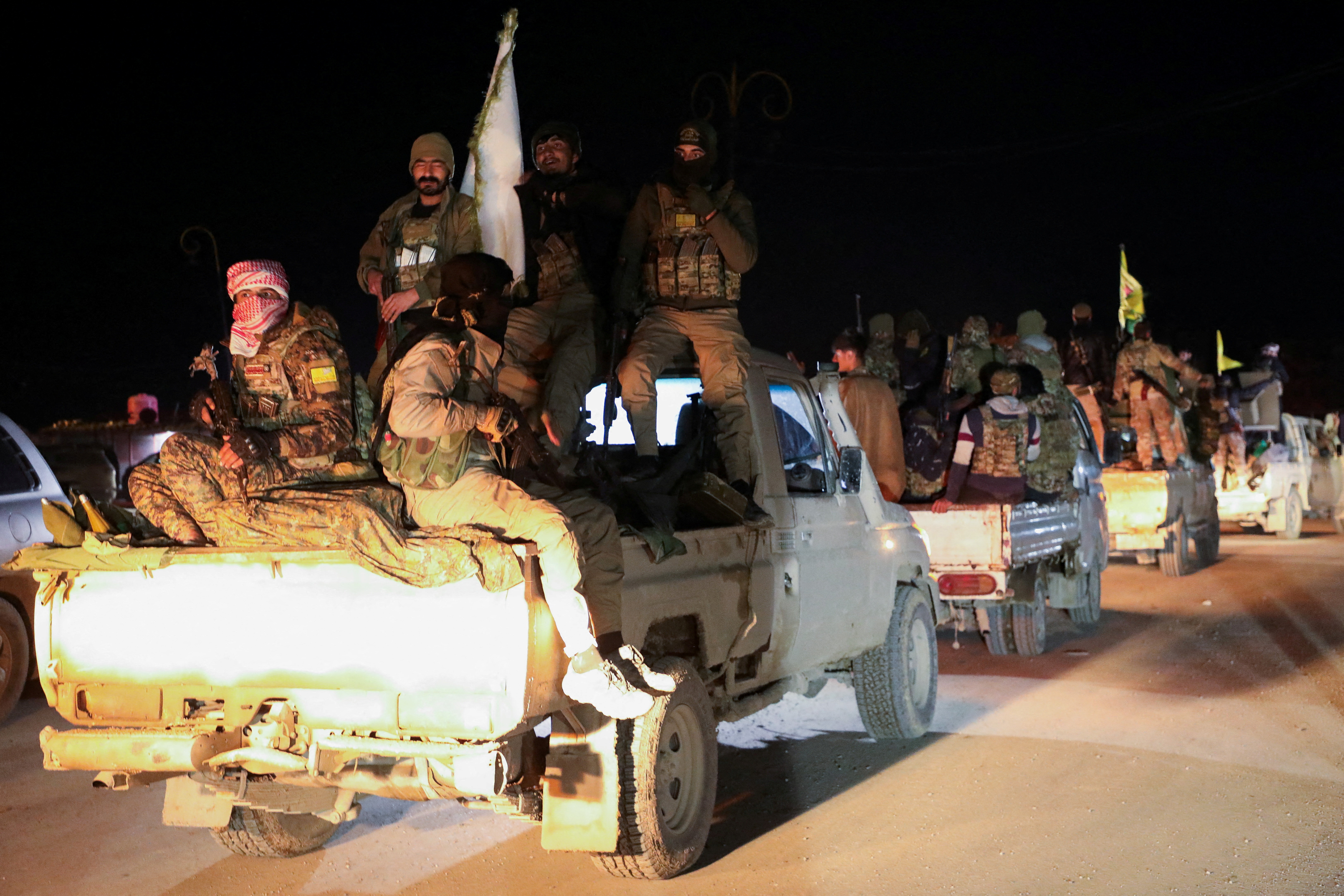 FILE PHOTO: Syrian Democratic Forces vehicles withdraw from the front lines, in Hasakah
