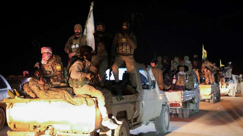 FILE PHOTO: Syrian Democratic Forces vehicles withdraw from the front lines, in Hasakah