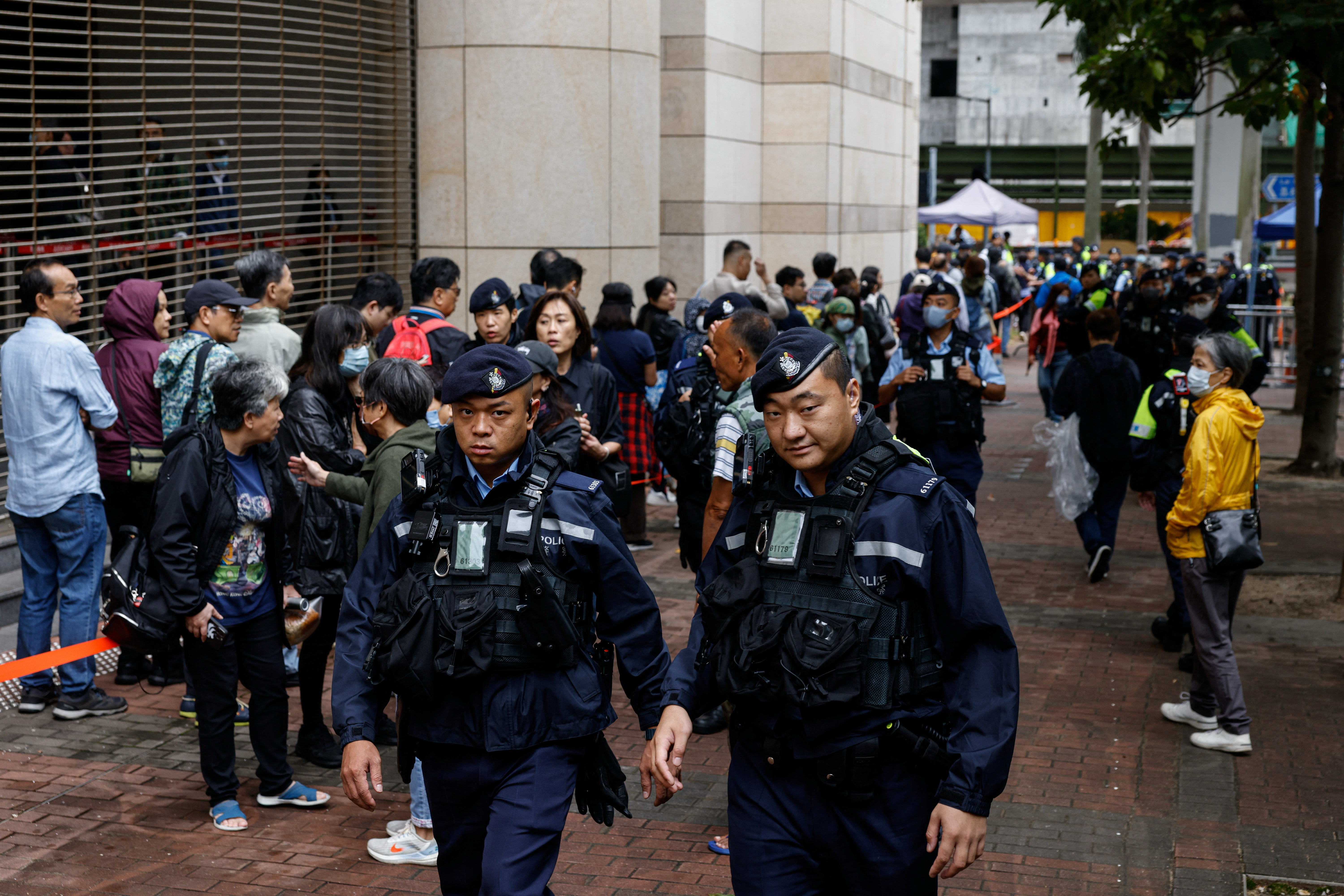 Police patrol outside the West Kowloon Magistrates' Courts building before the sentencing against the 45 convicted pro-democracy activists charged under the national security law, in Hong Kong