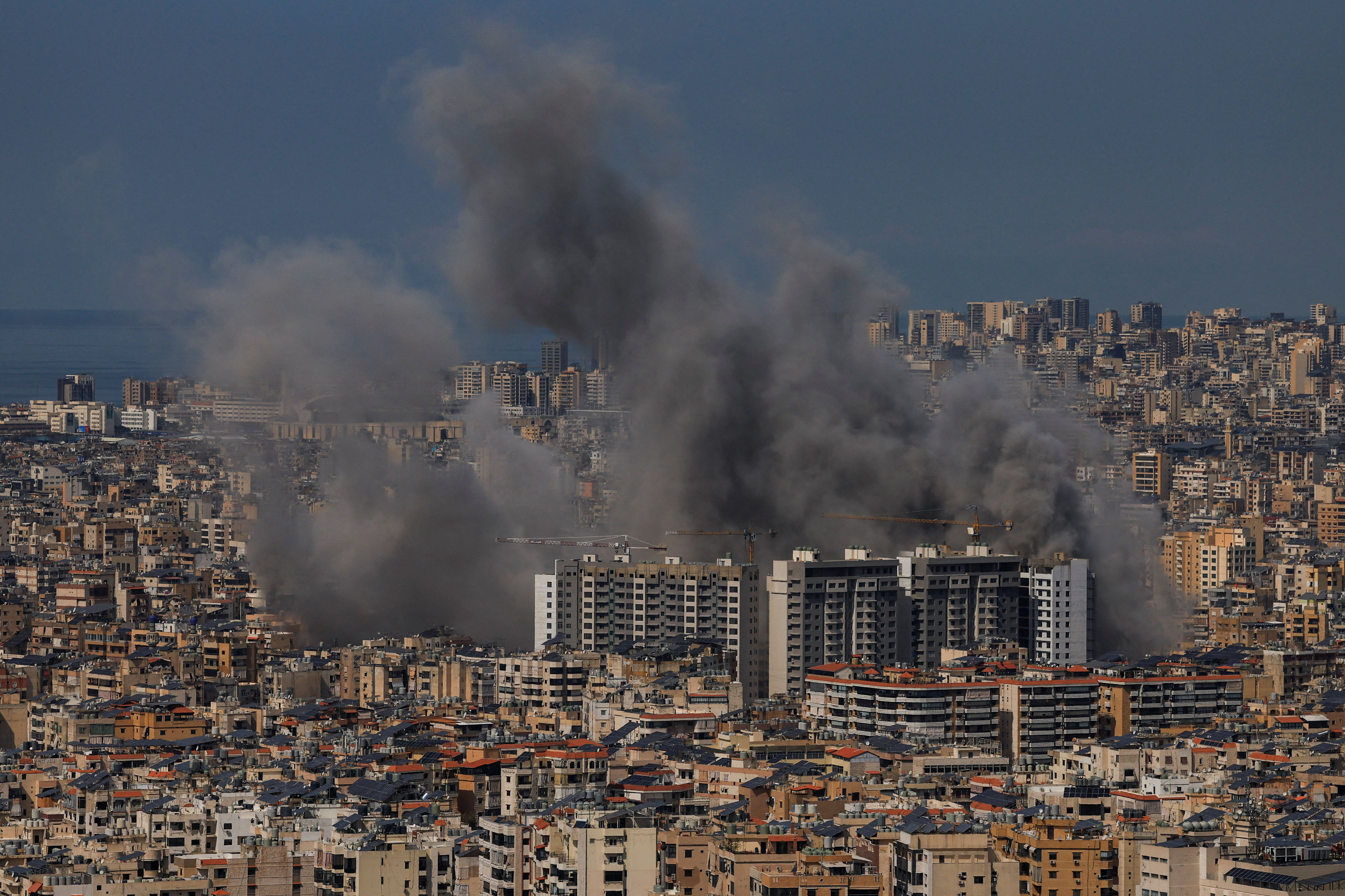 Smoke billows after reported strikes on Beirut’s southern suburbs, as seen from Baabda
