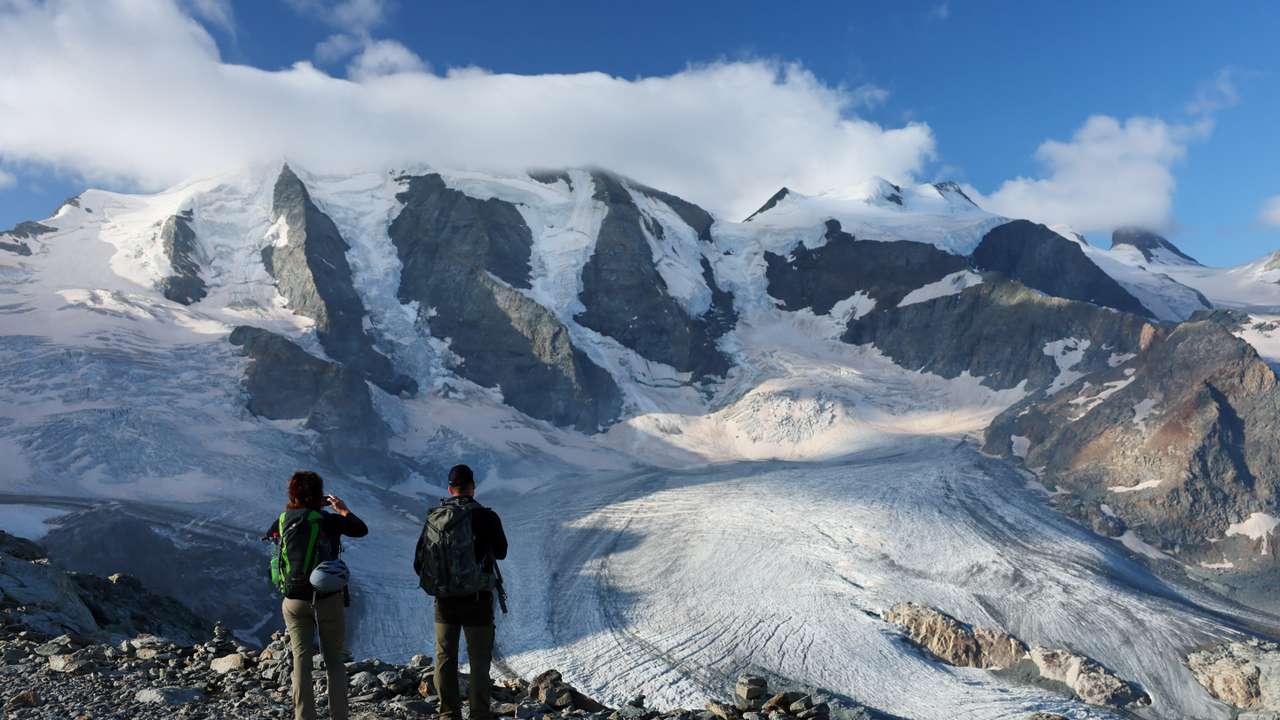 FILE PHOTO: Hikers take a picture of Pers Glacier amid climate change, in Pontresina
