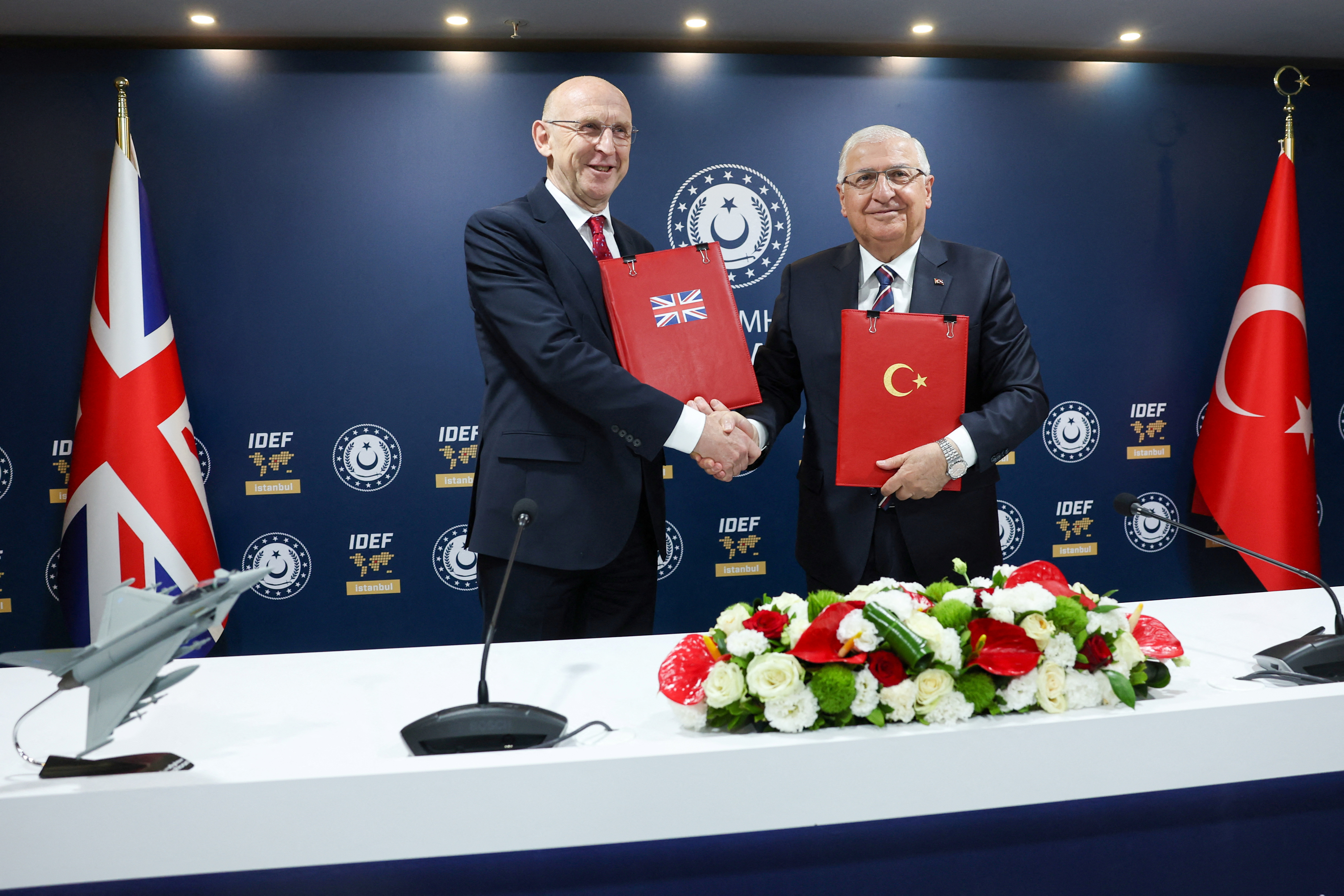 Turkish Defence Minister Guler and British Defence Secretary Healey attend a signing ceremony in Istanbul