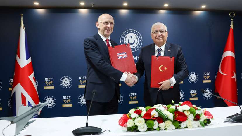 Turkish Defence Minister Guler and British Defence Secretary Healey attend a signing ceremony in Istanbul