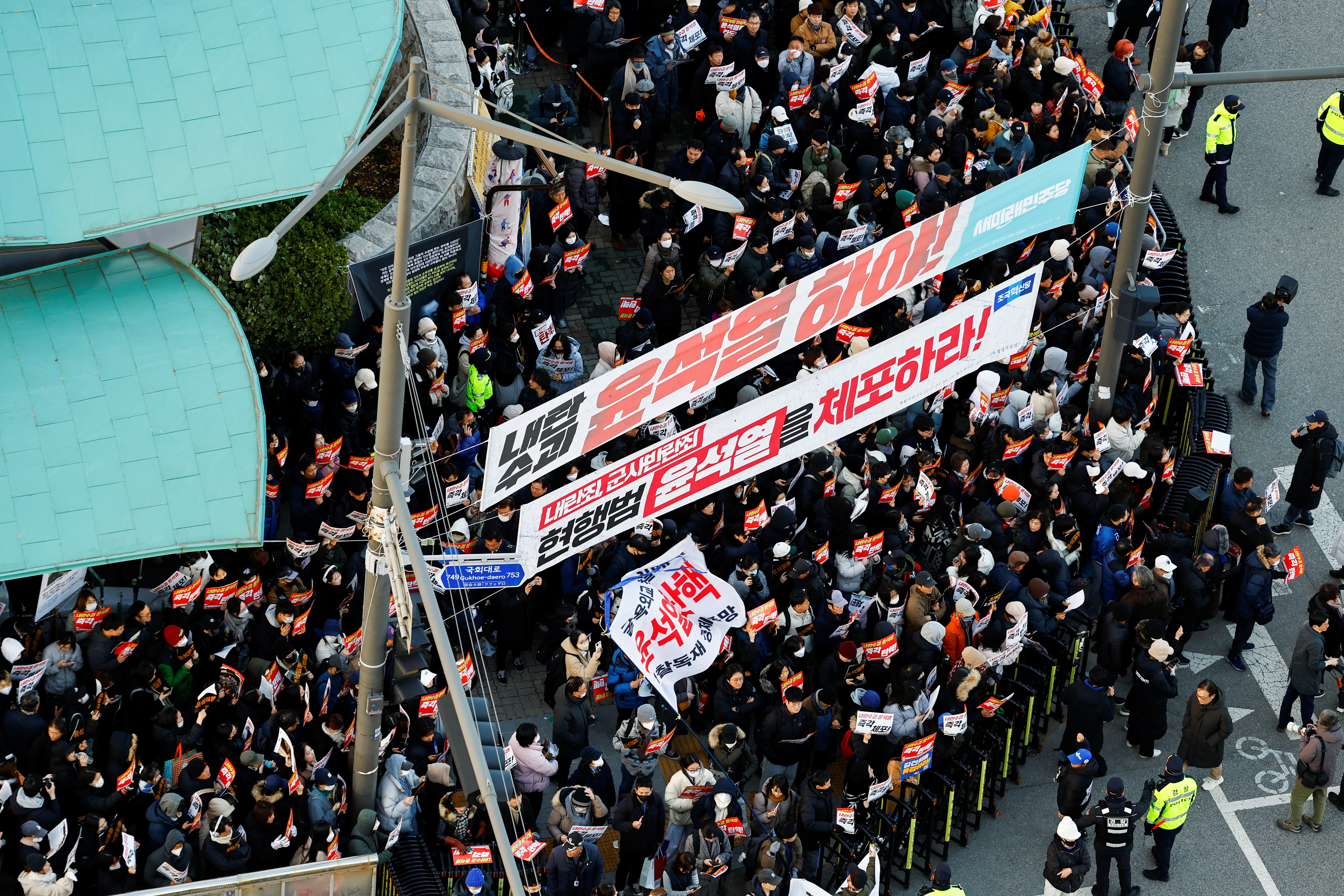 Demonstrators take part in a protest in front of the National Assembly in Seoul