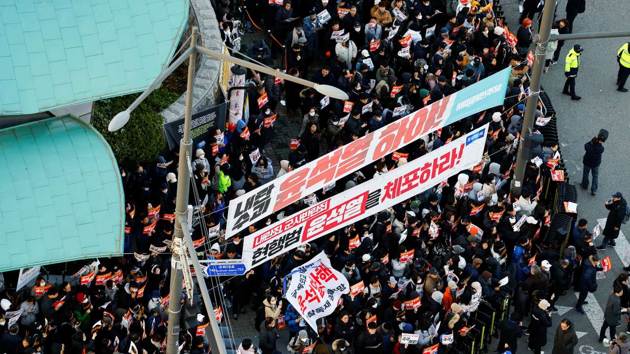 Demonstrators take part in a protest in front of the National Assembly in Seoul