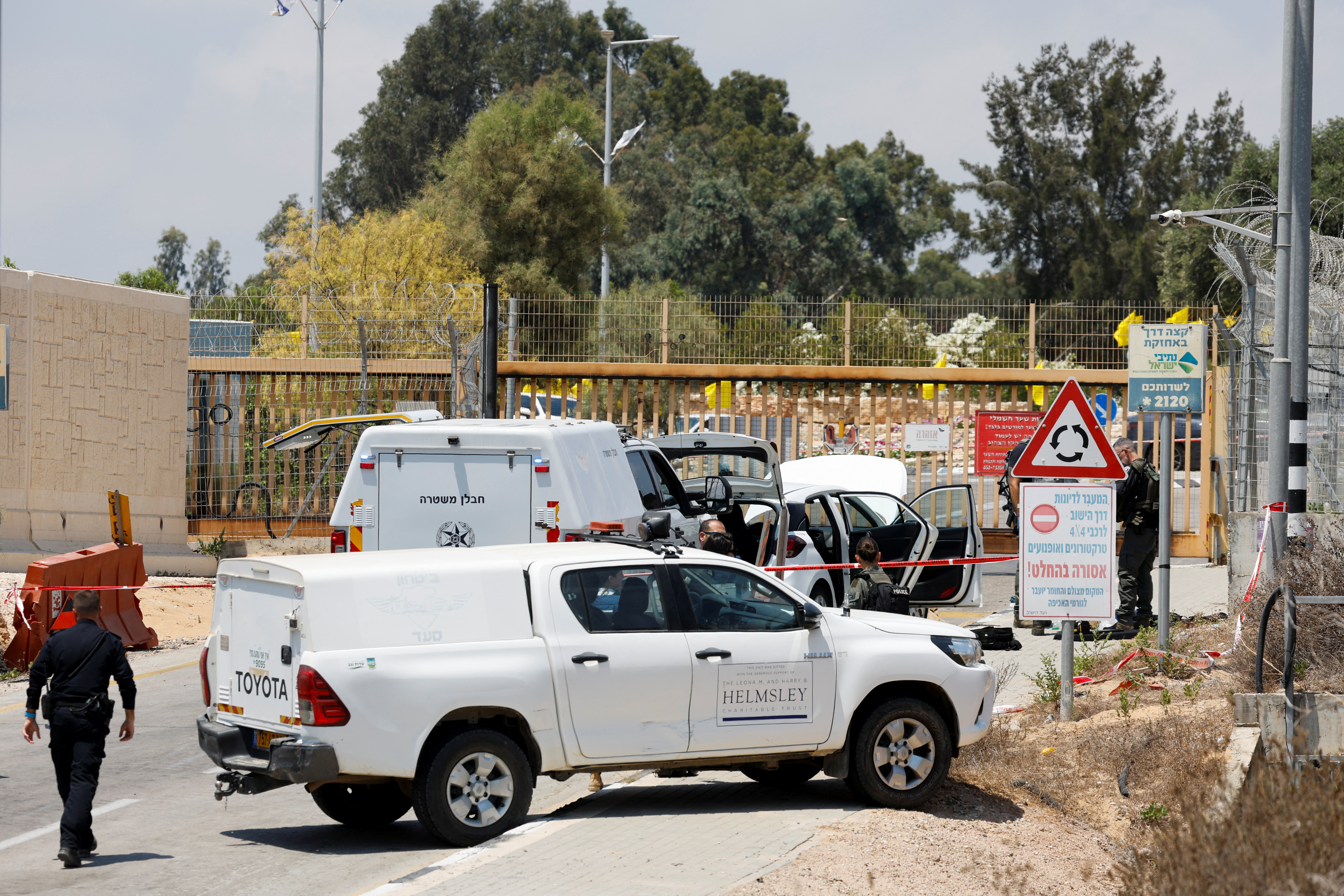 Israeli officials work at the scene of an attempted stabbing attack, in Netiv Haasara