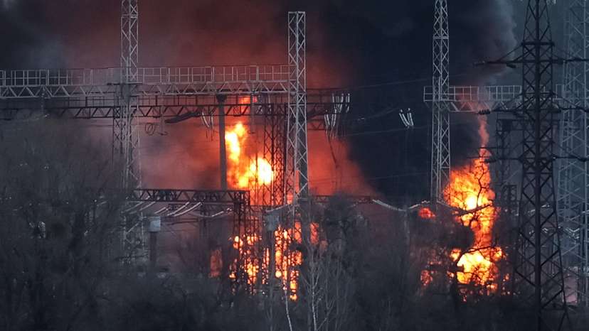Smoke and fire are seen around high-voltage lines at a site of a Russian missile strike outside Kharkiv