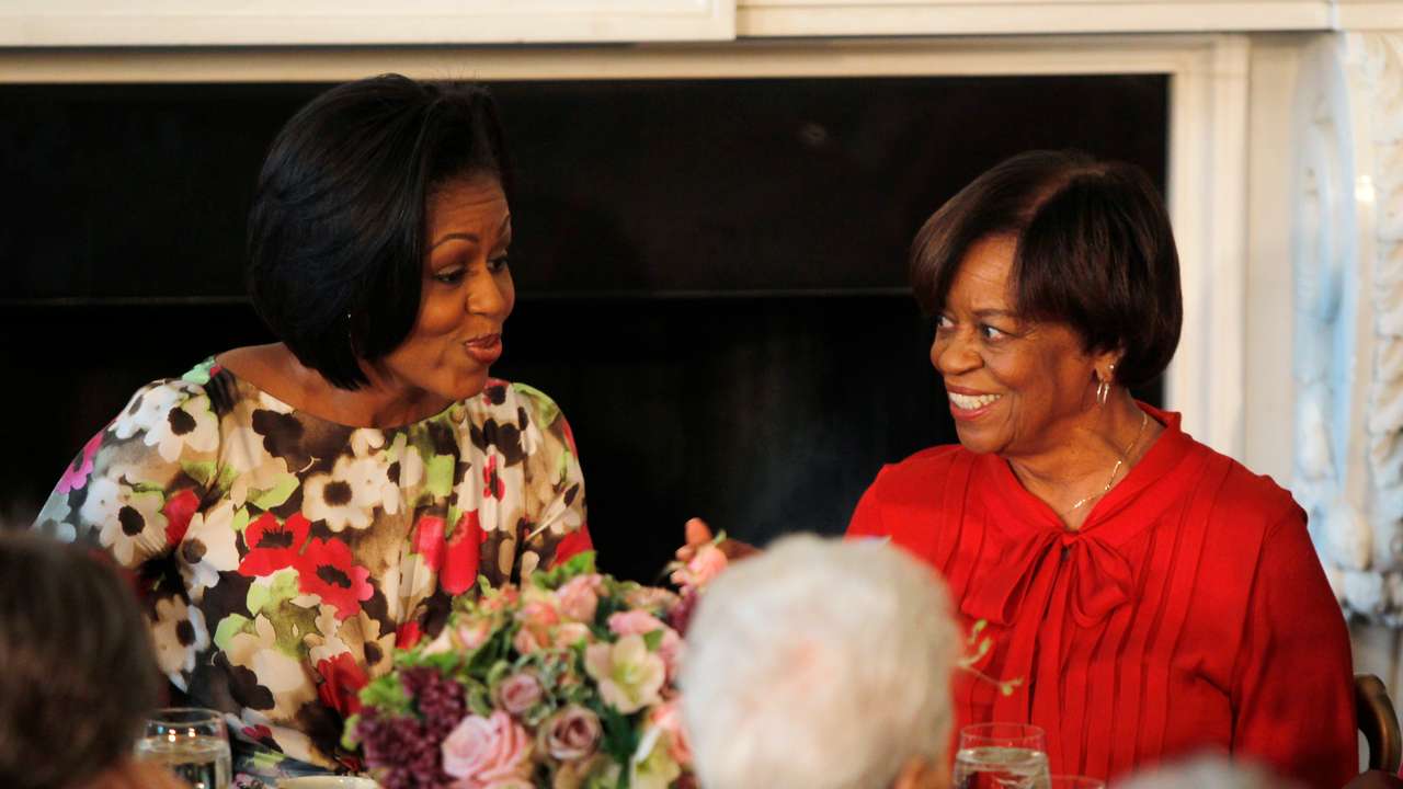 US first lady Obama sits alongside her mother Robinson as she hosts a Mother's Day event in Washington