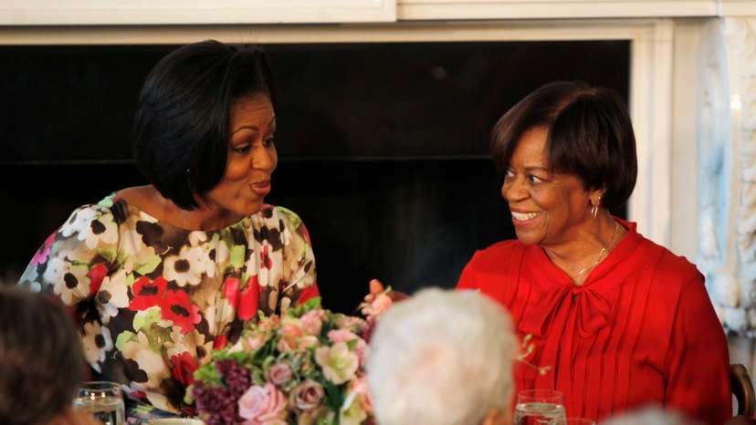 US first lady Obama sits alongside her mother Robinson as she hosts a Mother's Day event in Washington