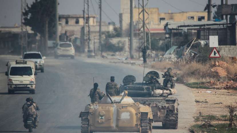 Rebels led by the Islamist militant group Hayat Tahrir al-Sham drive along a street in al-Rashideen, Aleppo province