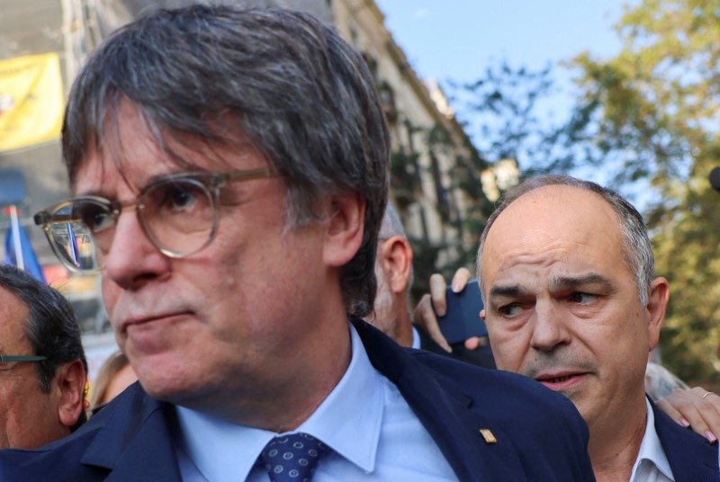 Carles Puigdemont, leader of Catalan separatist party Junts and secretary general Jordi Turull attend a welcoming event organised by the party in Barcelona