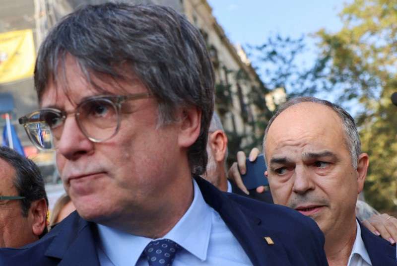 Carles Puigdemont, leader of Catalan separatist party Junts and secretary general Jordi Turull attend a welcoming event organised by the party in Barcelona
