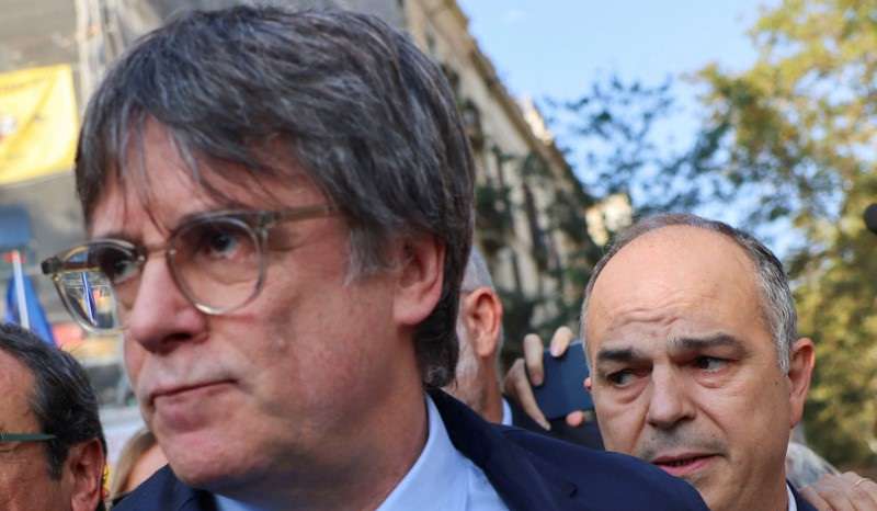 Carles Puigdemont, leader of Catalan separatist party Junts and secretary general Jordi Turull attend a welcoming event organised by the party in Barcelona