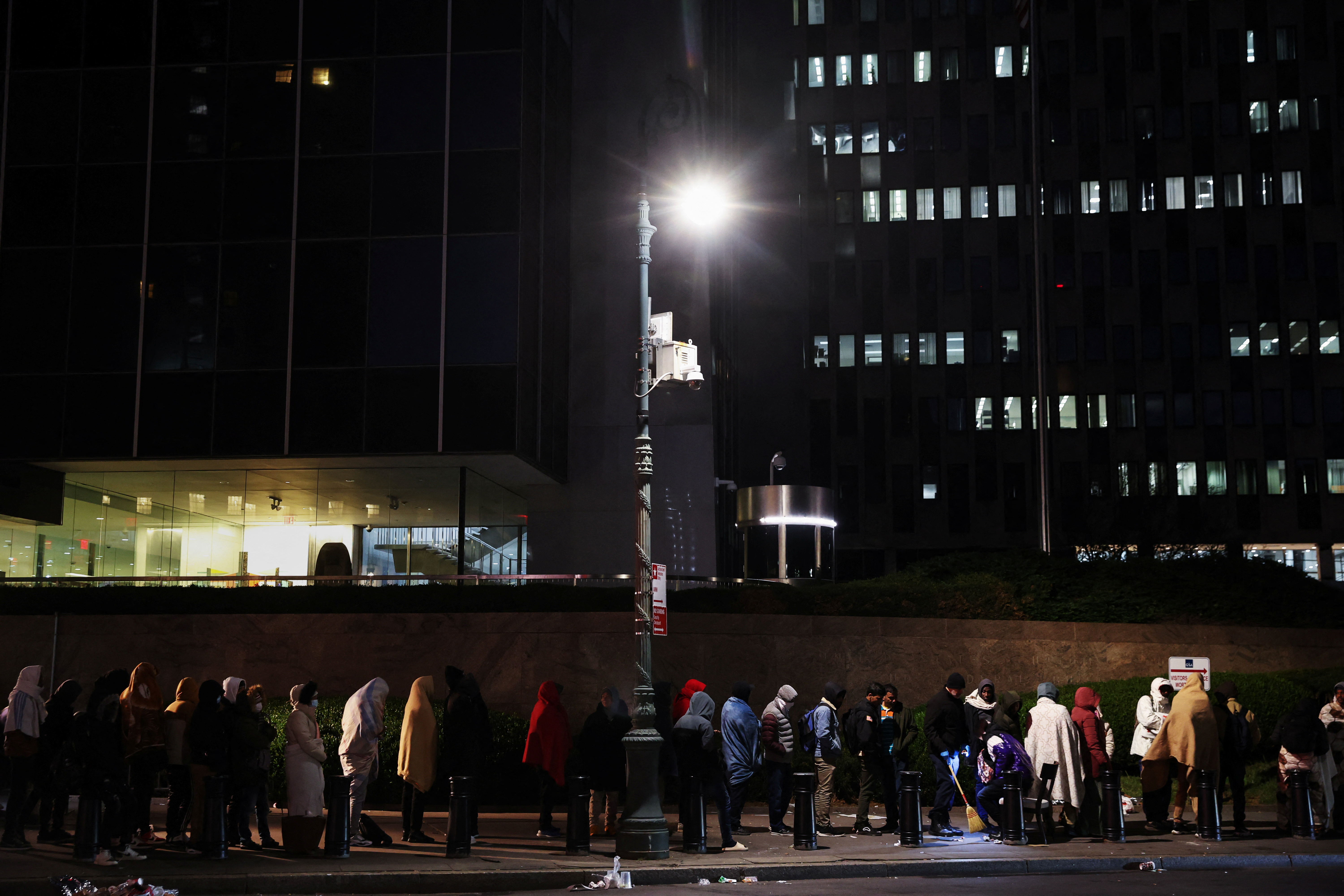Immigrants wait in line outside the Federal Plaza Immigration Court in New York City
