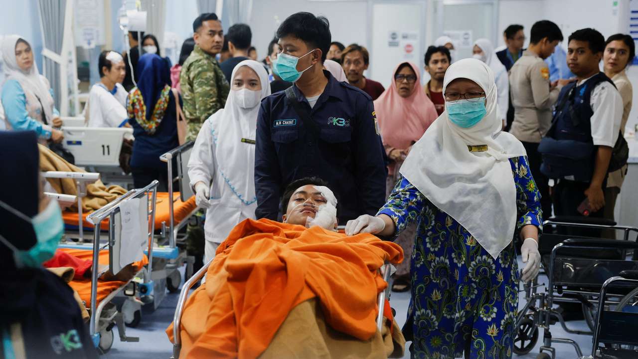 Medical workers push an injured student on the stretcher at Jakarta Islamic hospital after an explosion occurred during Friday prayers at a mosque inside a school complex in Jakarta