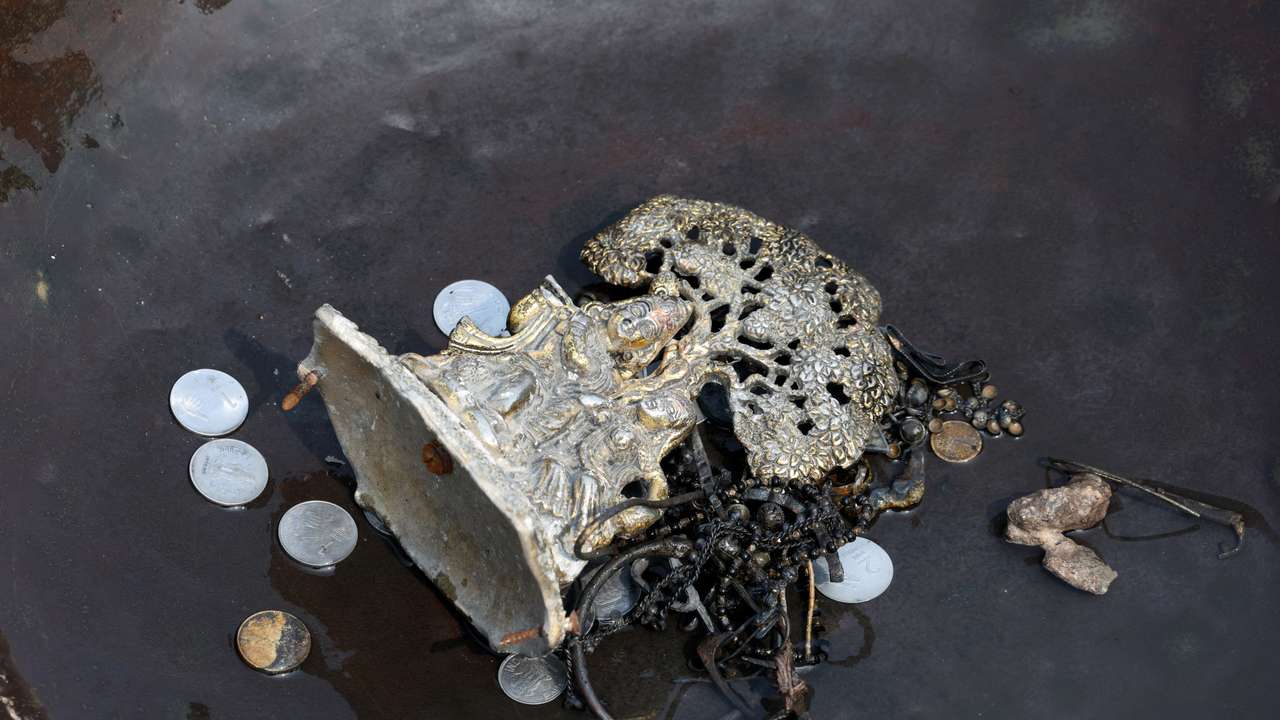 Items collected by people who go to the river to hunt for coins and other valuables from the waters of river Yamuna, are kept in a container