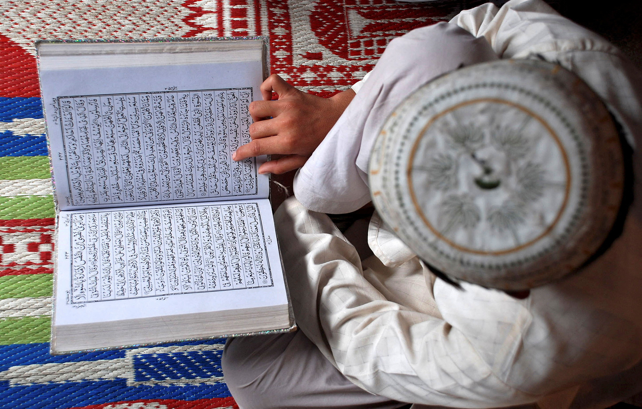 FILE PHOTO: A Muslim boy reads the Koran at a madrasa in Mathura, India