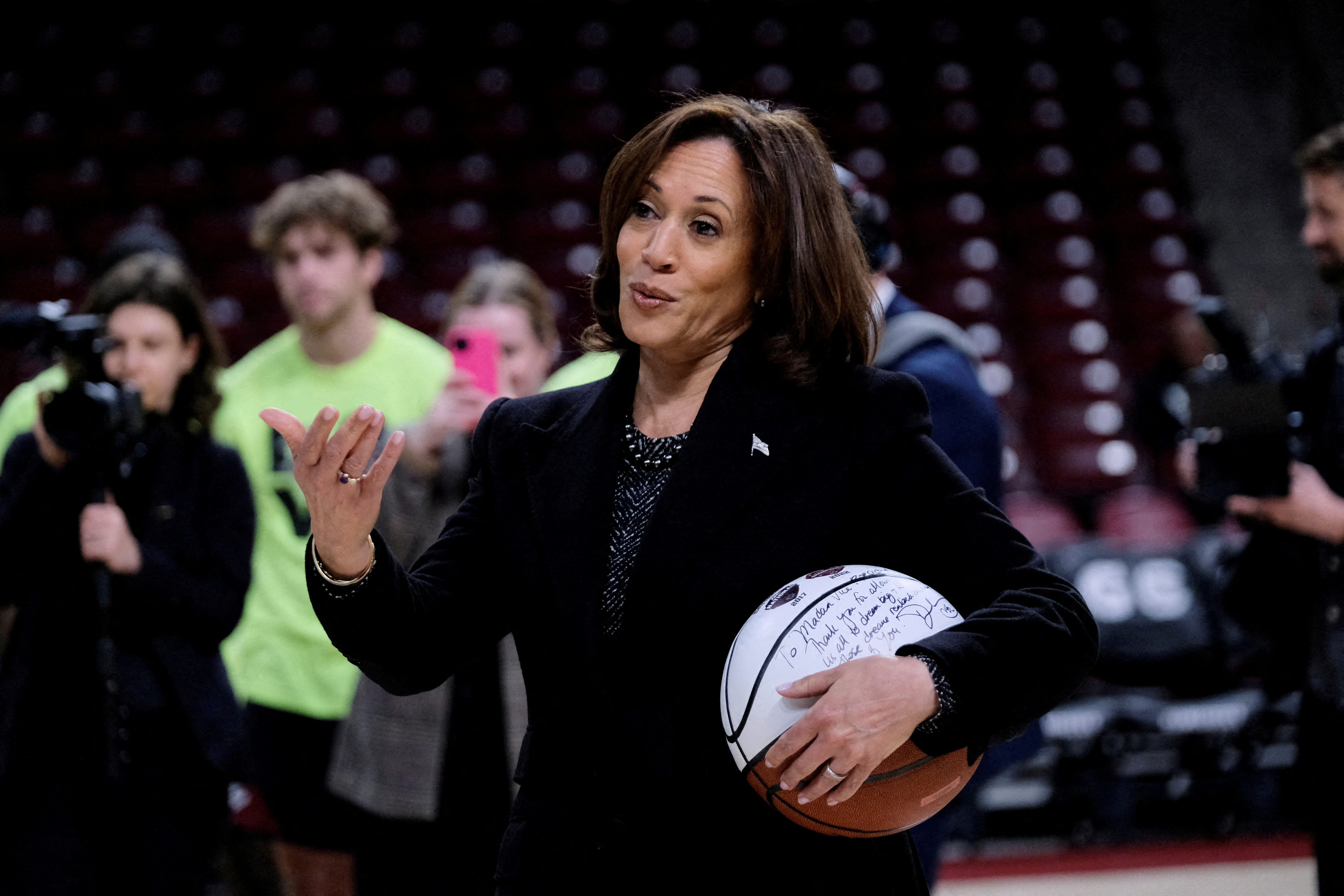 FILE PHOTO: FILE PHOTO: U.S. Vice President Kamala Harris holds a ball signed by the members of the currently number 1 ranked women's NCAA basketball team South Carolina Gamecocks during a visit in Columbia