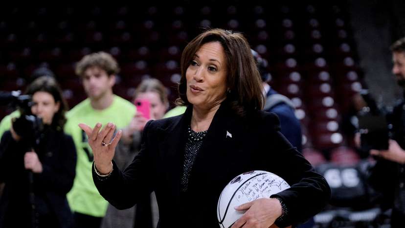 FILE PHOTO: FILE PHOTO: U.S. Vice President Kamala Harris holds a ball signed by the members of the currently number 1 ranked women's NCAA basketball team South Carolina Gamecocks during a visit in Columbia