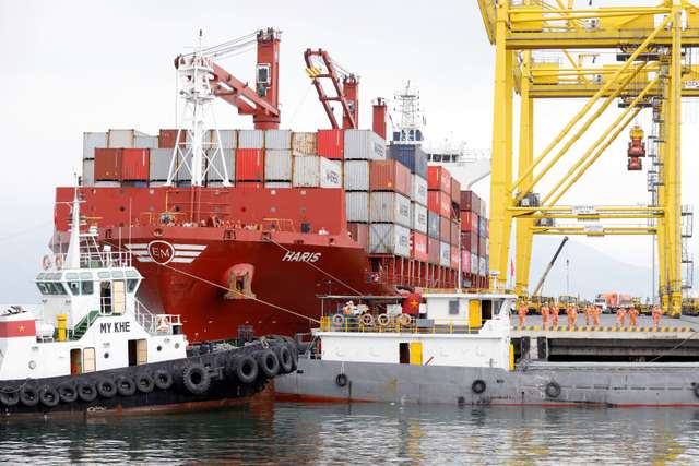 Containers are loaded onto a ship at Tien Sa port in Da Nang city